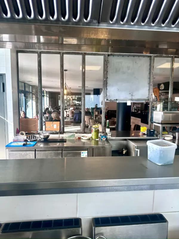 The restaurant dining room, friendly and warm, seen from the kitchen.